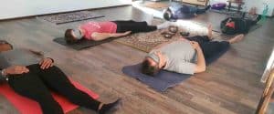 Partecipanti distesi supini a terra con bende sugli occhi durante una sessione di meditazione guidata e training autogeno, tecniche di meditazione Bodhi Vipal al Centro Zorba Il Buddha.